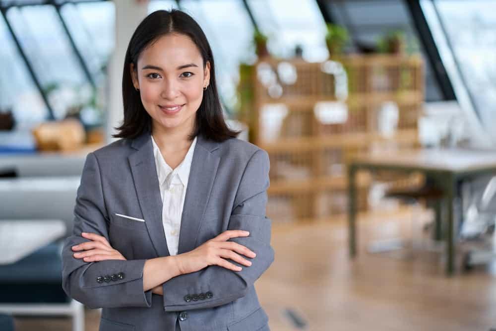 Young confident smiling Asian business woman leader