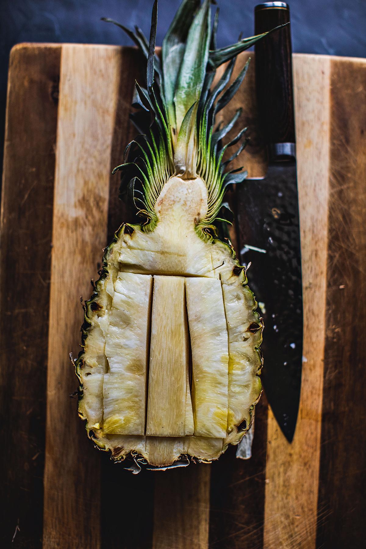 knife cutting pineapple core.