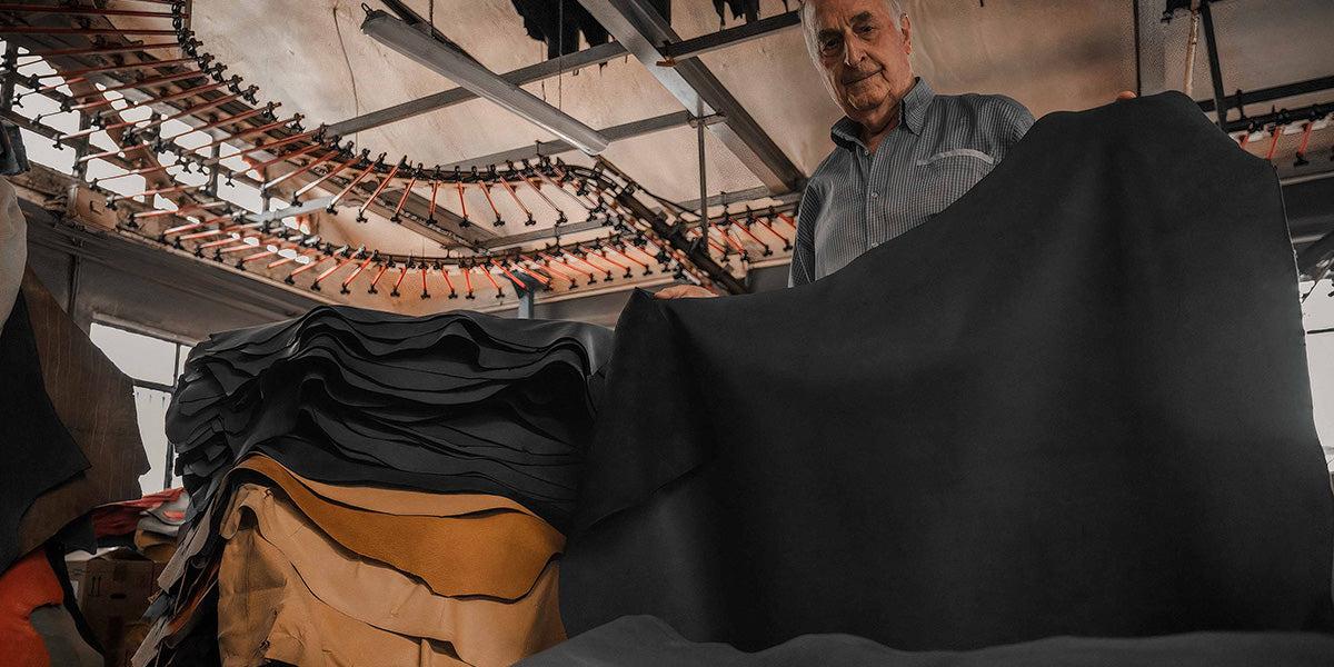 man holding piece of leather