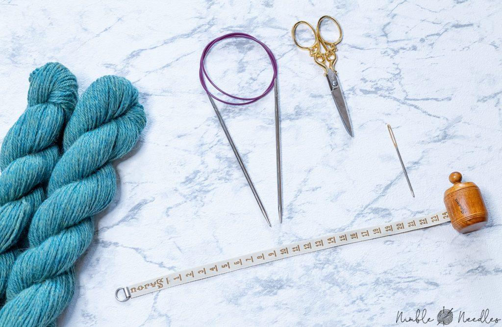 all the materials you need for knitting these fingerless gloves