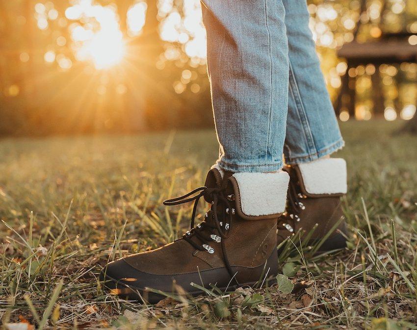 Cover image of a person wearing really cute Shapen Barefoot Lynx warm boots against a setting sun.