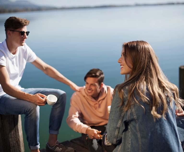 A group of people sitting on a boat dock