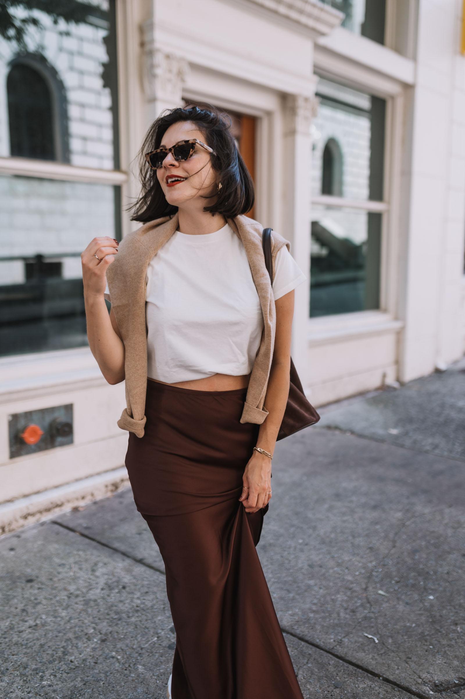 Jessica Camerata wears a brown satin maxi skirt and white tee