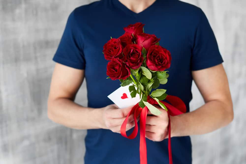man with red roses
