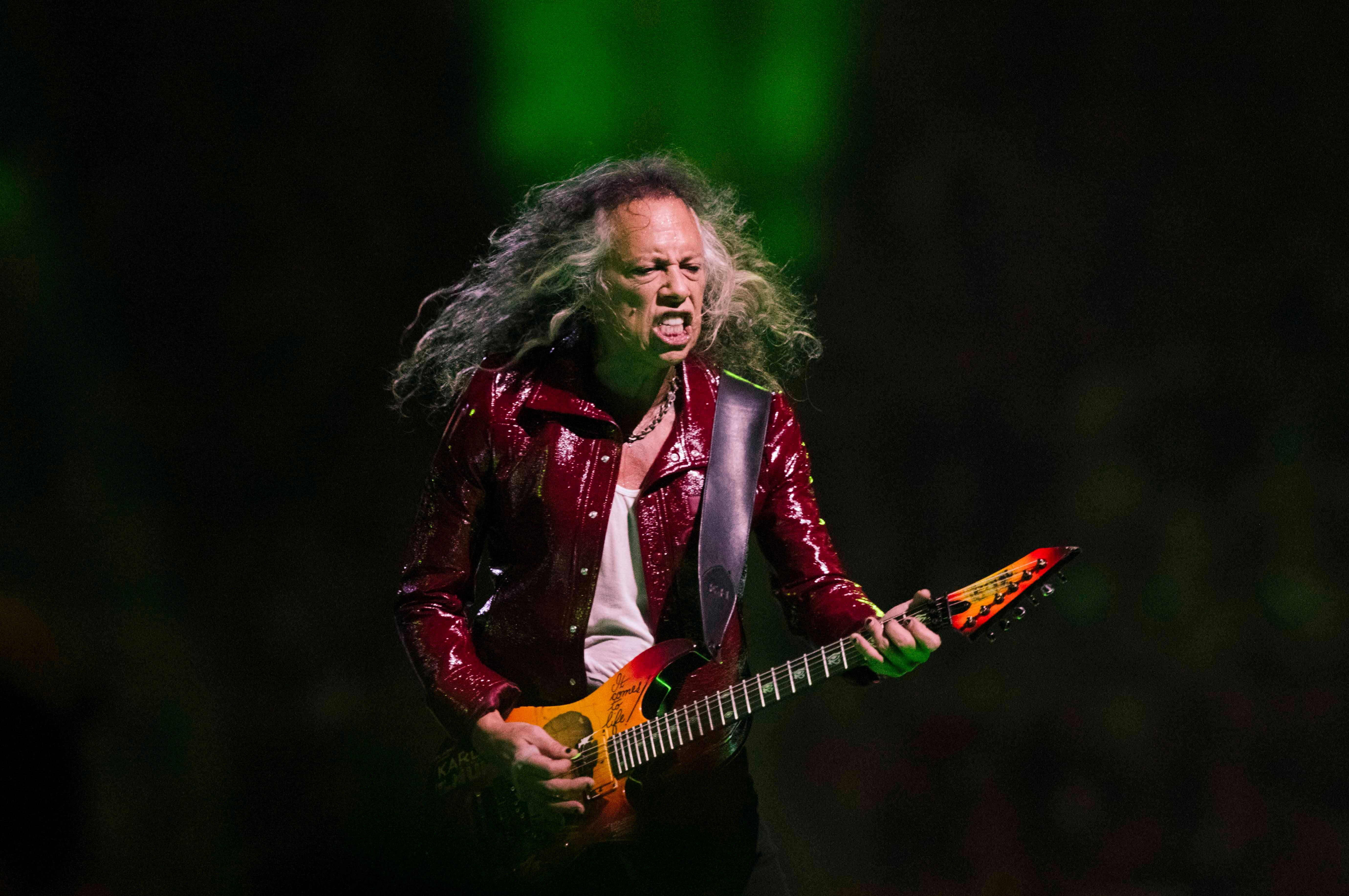 Metallica lead guitarist Kirk Hammett performs during the band’s M72 World Tour on the first night of a no-repeat weekend at Ford Field on Friday, Nov. 10, 2023. (John T. Greilick, The Detroit News)