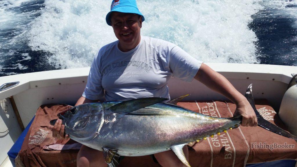 A sportfisherman holding a large Bluefin Tuna caught while tuna fishing in the Mediterranean