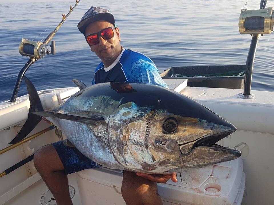 Three anglers holding a Yellowfin Tuna they caught while fishing in Venice, LA.