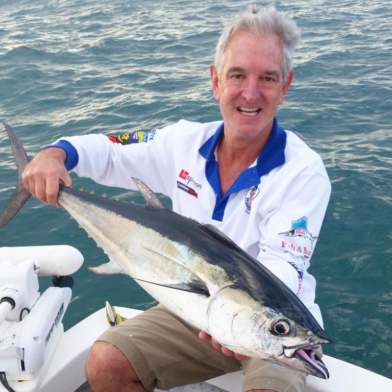 Two anglers holding a Blackfin Tuna