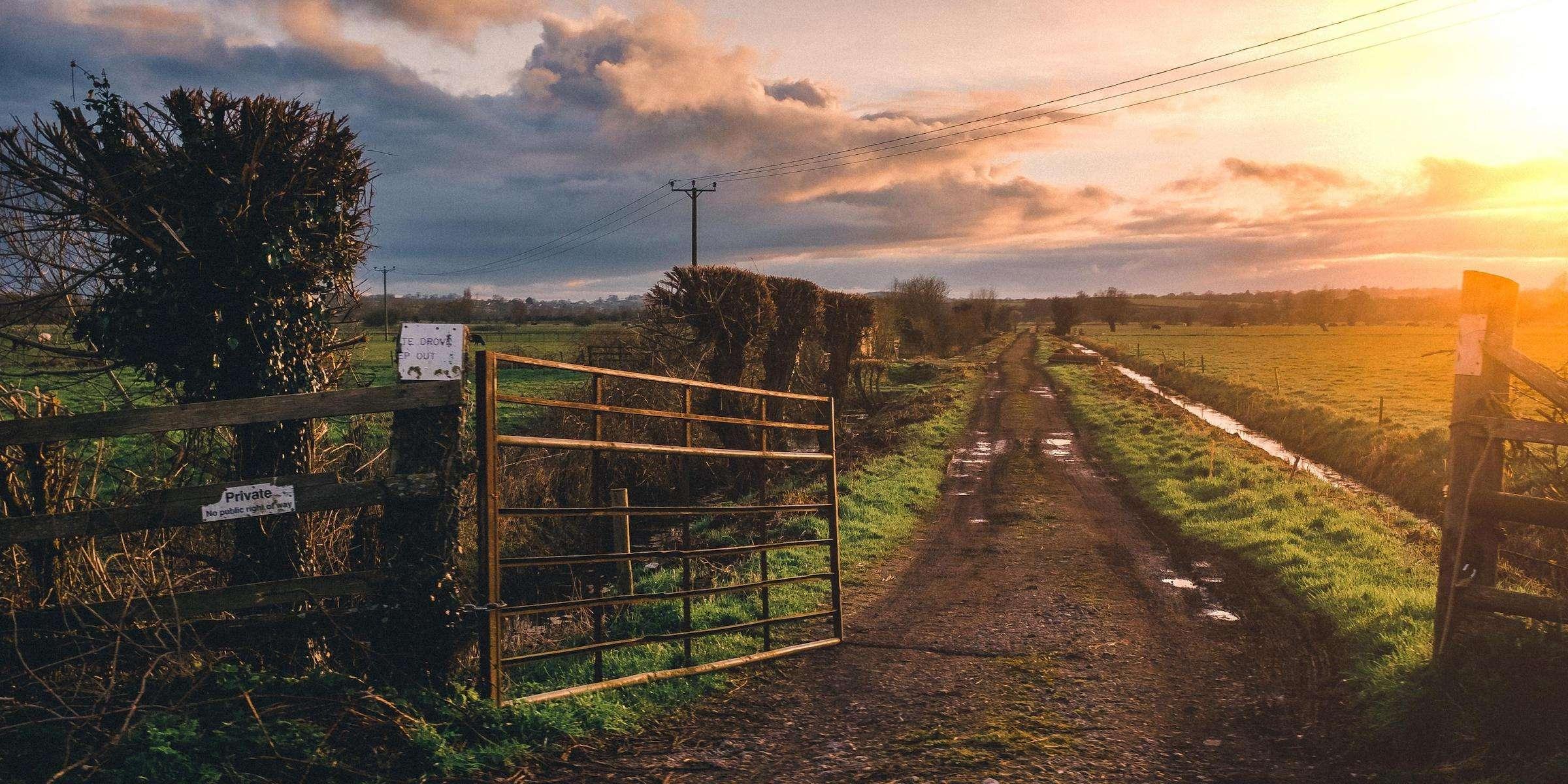 Farm at sunset by gate