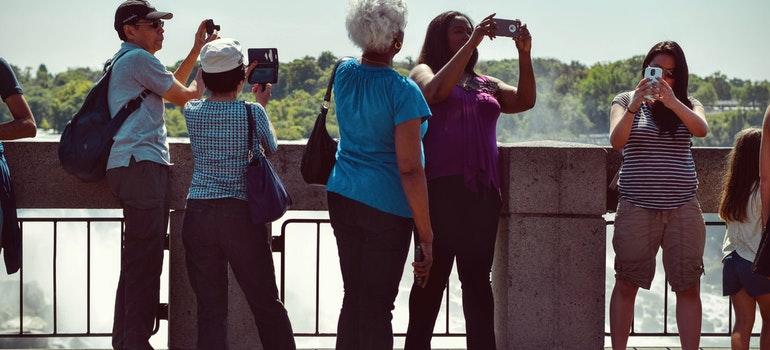 Tourists are taking pictures of a place.