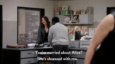 A woman in a black dress says that Alice is obsessed with her