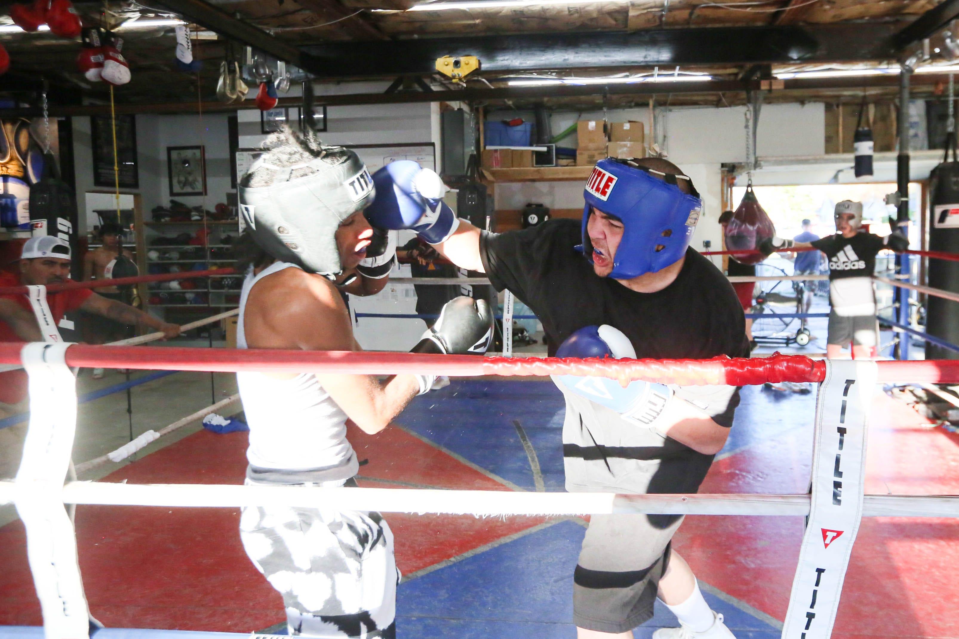 Johnny Lopez, right, boxes during practice at the Reno County Boxing Academy Thursday, Aug. 11, 2022.