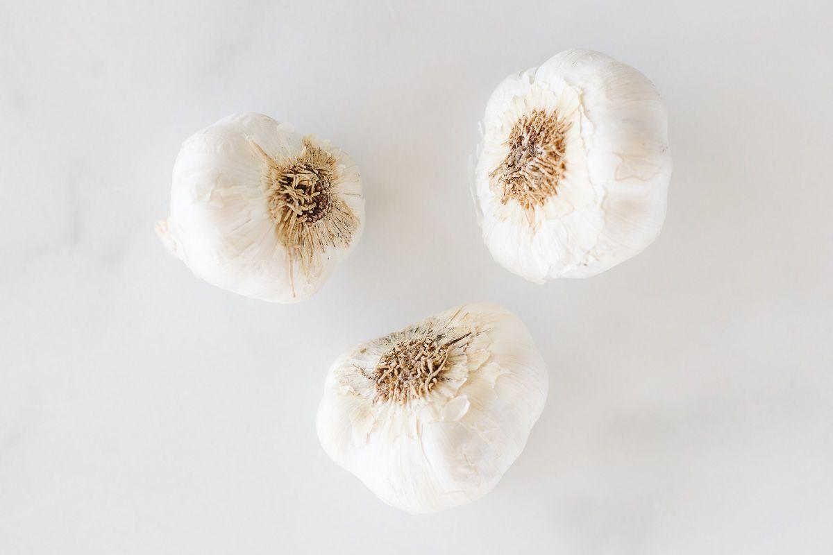 Cloves of garlic on a marble countertop.