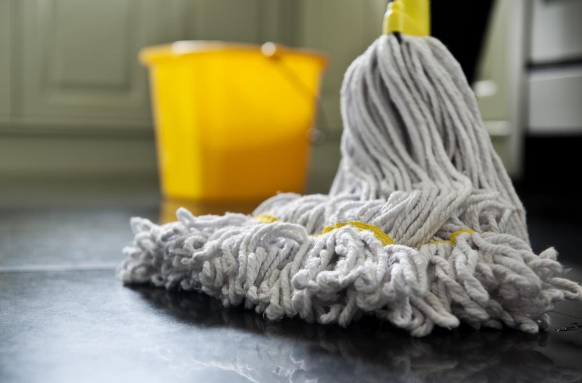 close up photograph of a mop and bucket with shallow depth of field