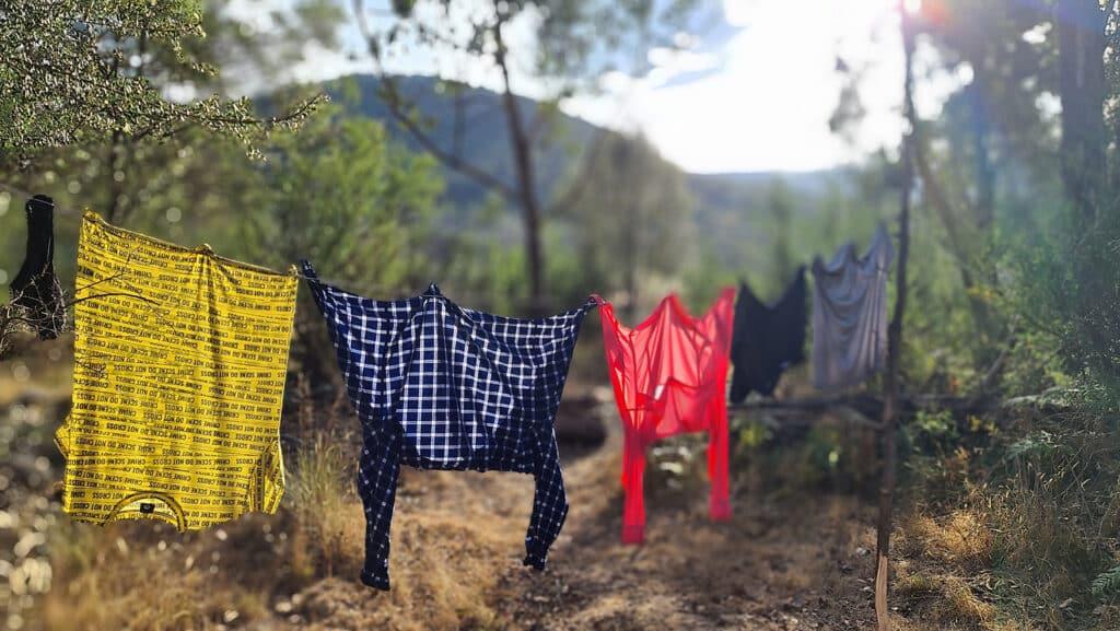 Wet clothes hanging on a line to dry.