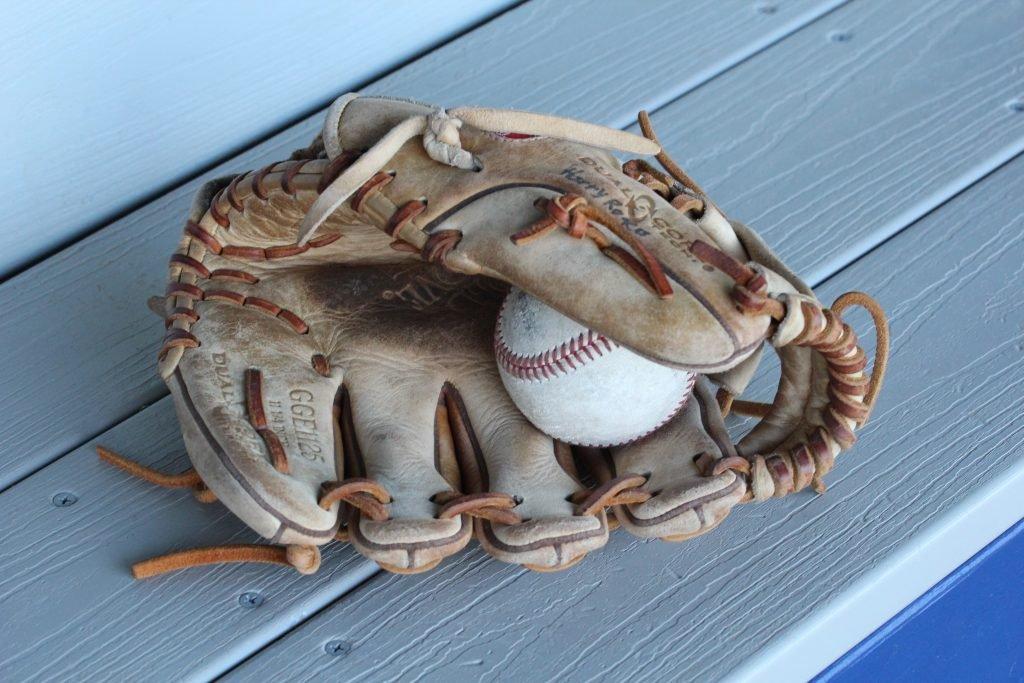 An image of a dirty, used and dry baseball glove holding a baseball. How would you dye this glove?