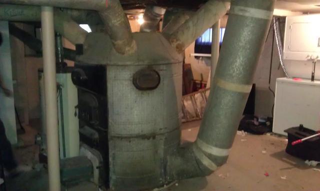 A gravity fed furnace is lined with asbestos