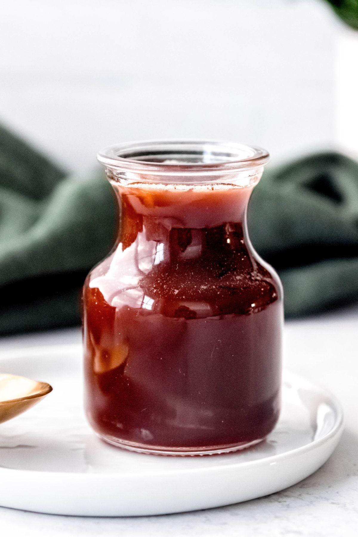 closeup shot of Irish cream syrup jar in front of a green cloth.