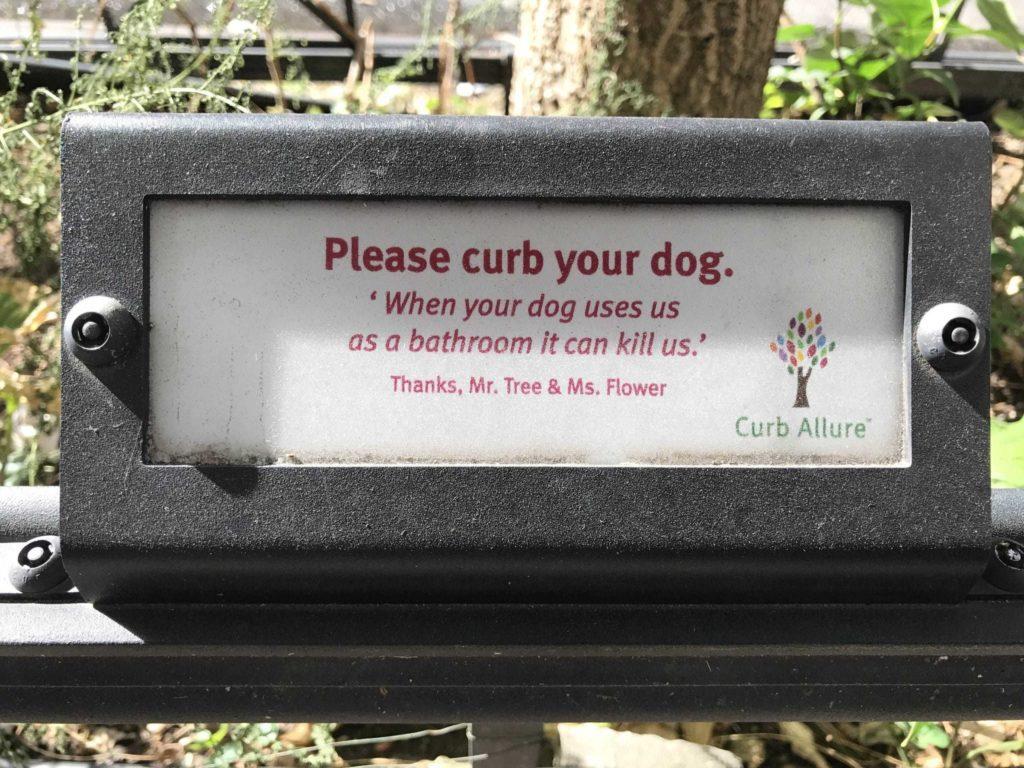 Sign that says: "Please curb your dog. When your dog uses us as a bathroom it can kill us." From Curb Allure