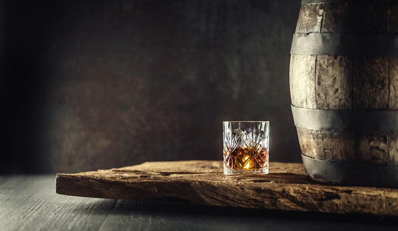 glass bourbon on wood table