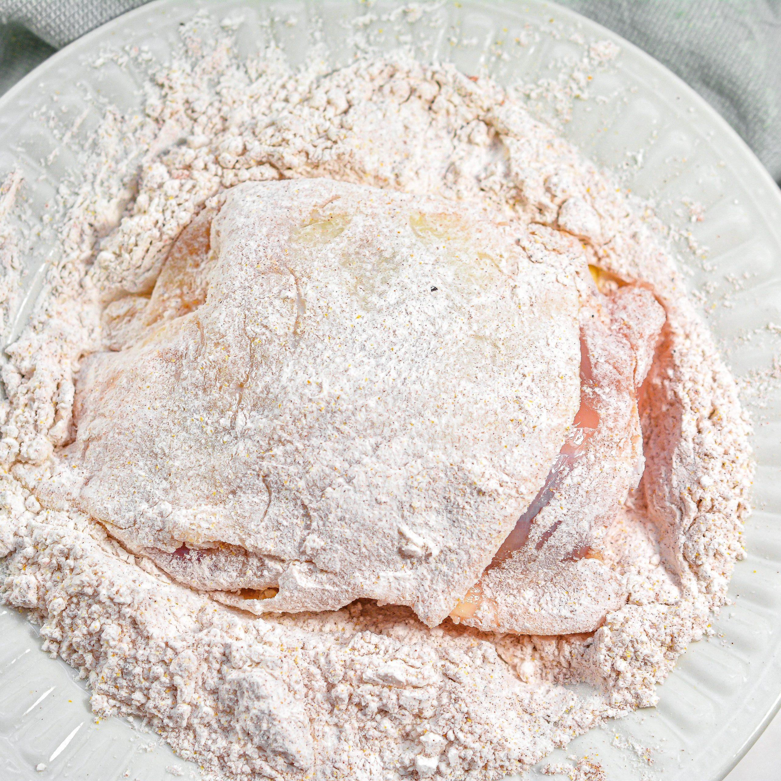 Dredge the chicken well in the flour mixture