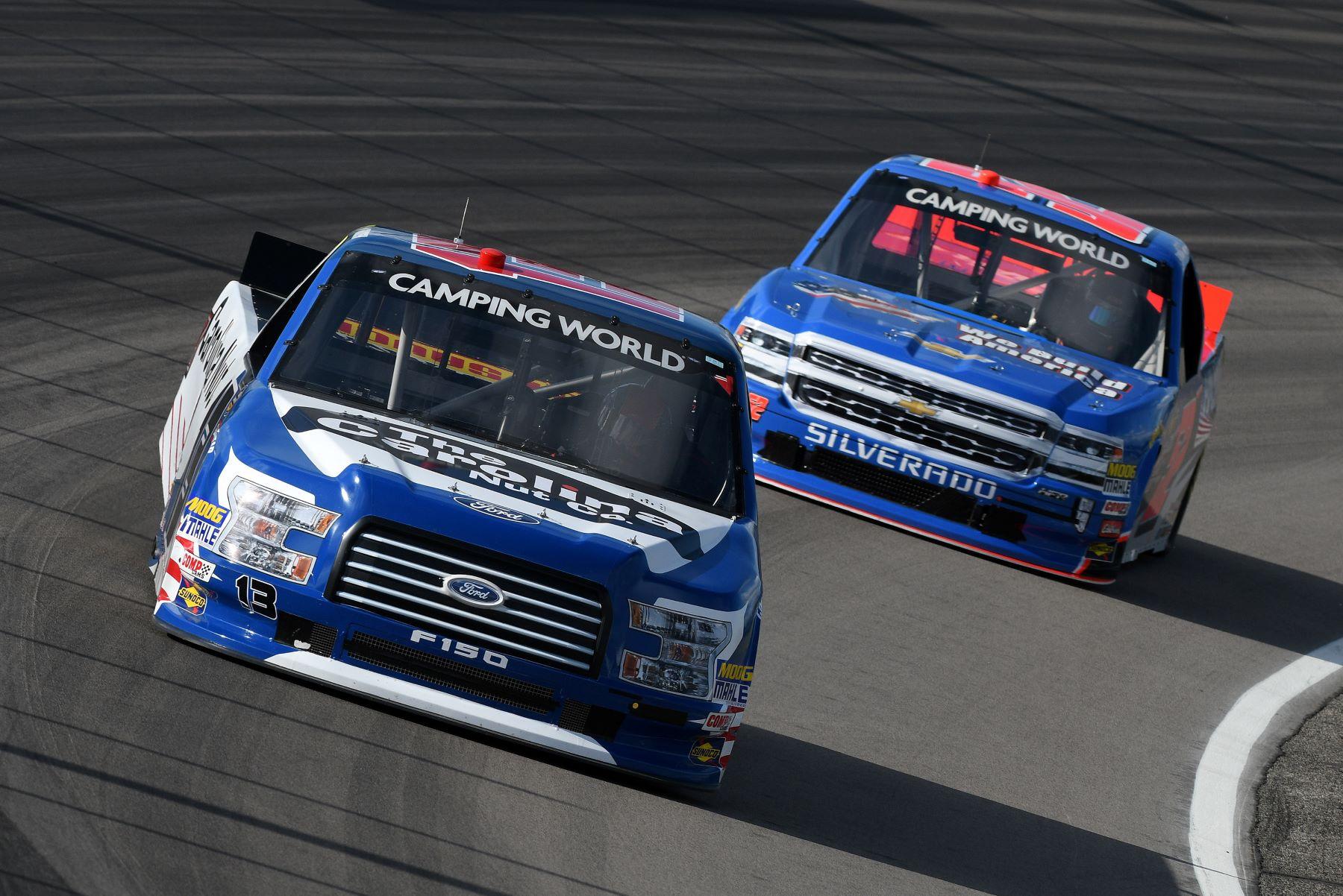 Ford F-150 and Chevy Silverado NASCAR trucks racing during Camping World Truck Series in Madison, Illinois