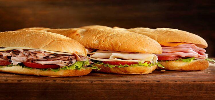 three submarine sandwiches