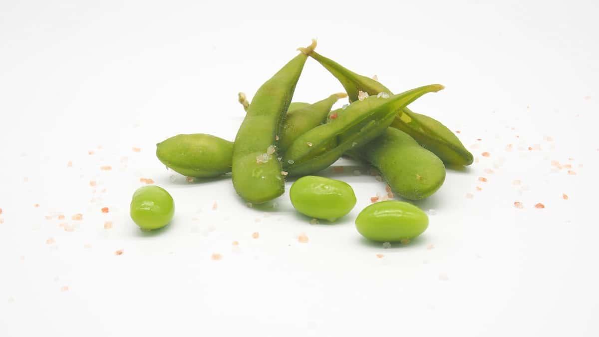 Edamame in the pod and shelled edamame sprinkled with salt to show mukimame vs edamame