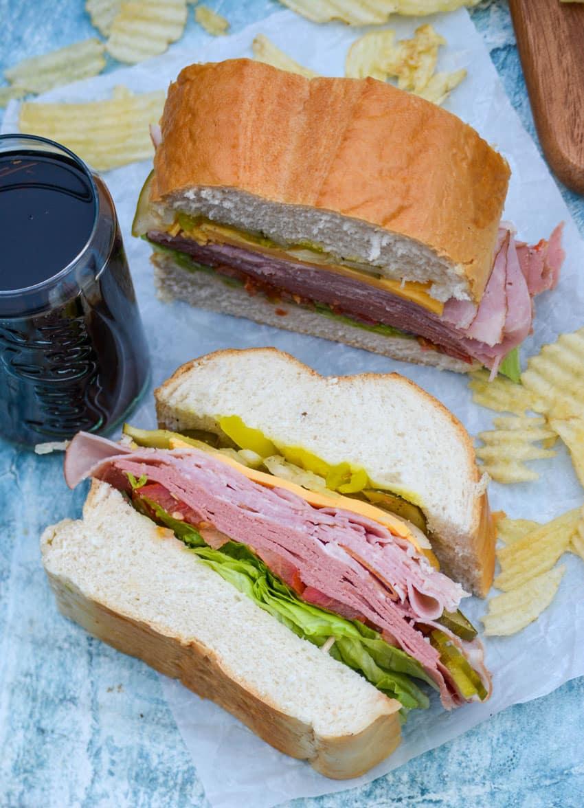 slices of Italian style deli sub sandwiches on a light blue background