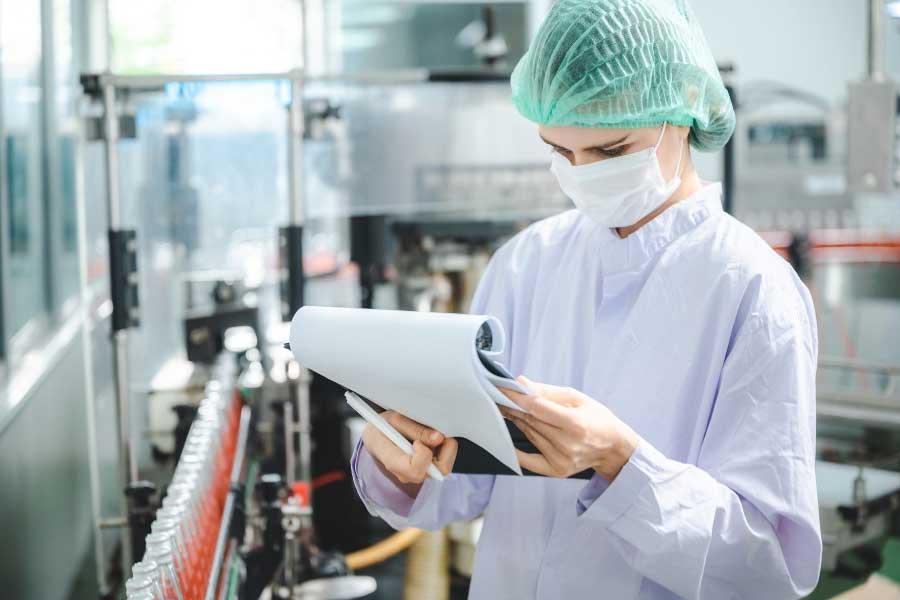 employee checking the quality of bottle products