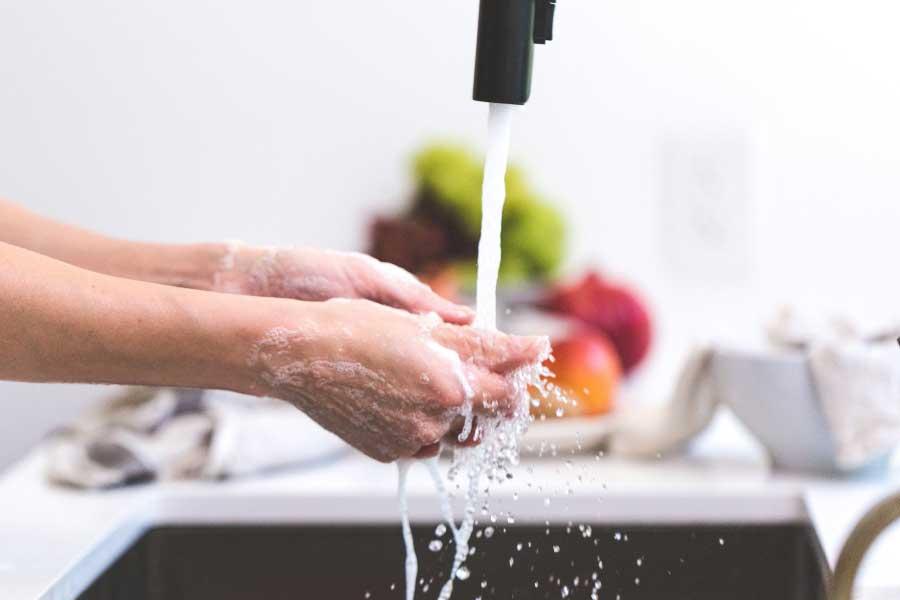 woman washing hands before cooking