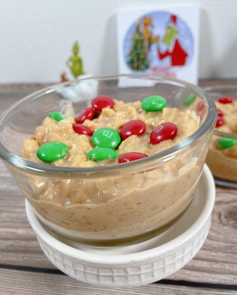 Close up image of pudding, garnished with candies, sits on a white cupcake stand.