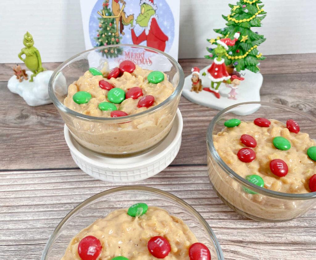 Close up image of pudding in glass bowls surrounded by Grinch decor.