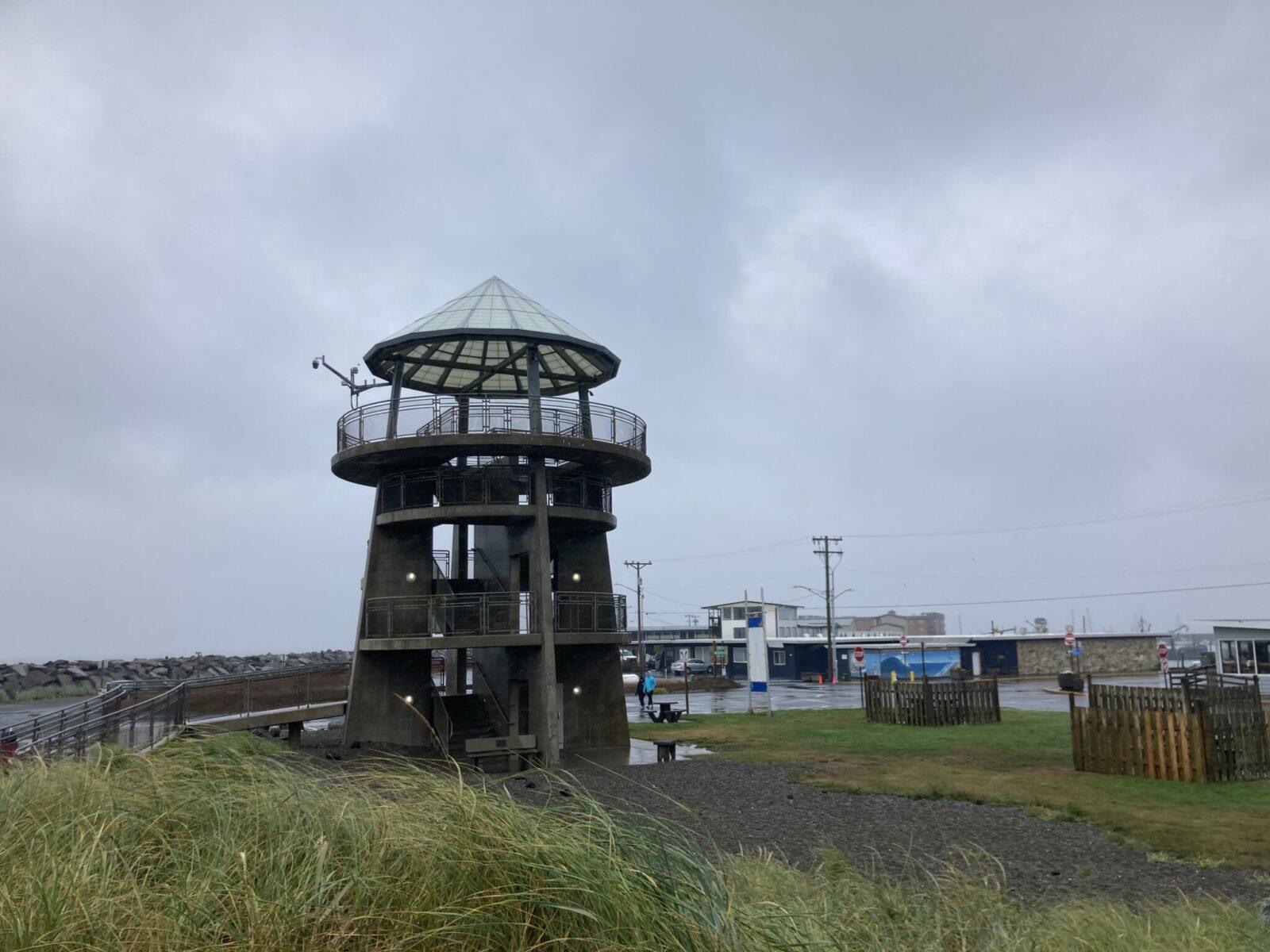 A concrete structure with stairs leading up to an observation tower on a rainy day in Westport.