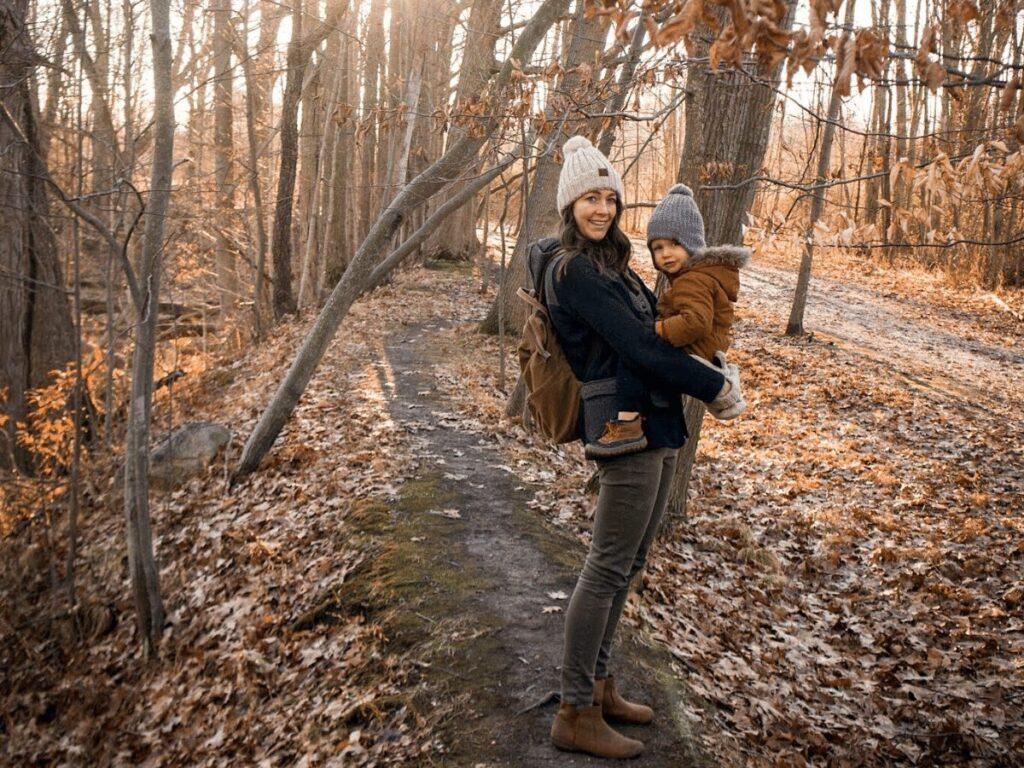 Mom holds small boy on hiking path: outdoor winter activities that don