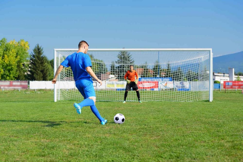 a soccer player with blue gym wearing plays soccer