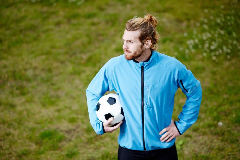 a soccer player tied up hair for the soccer game