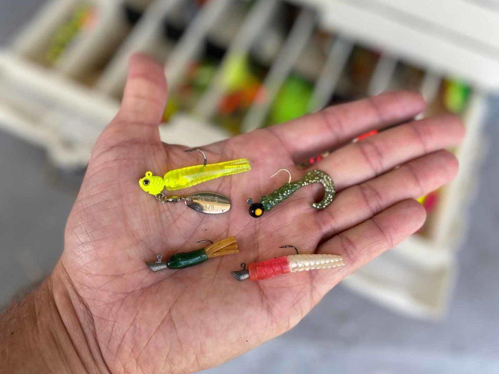 A variety of fishing lures in a man