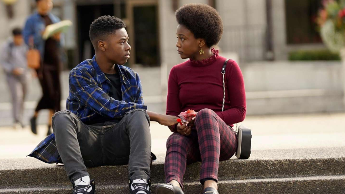 Two characters in "The Chi" are looking at each other.