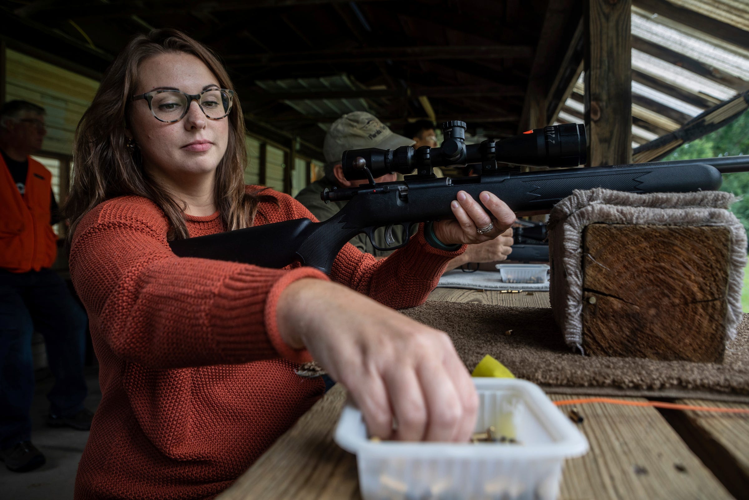 Kendra Knapp prepares to reload her rifle during a Hunter Safety Field Day at the Washtenaw Sportsman