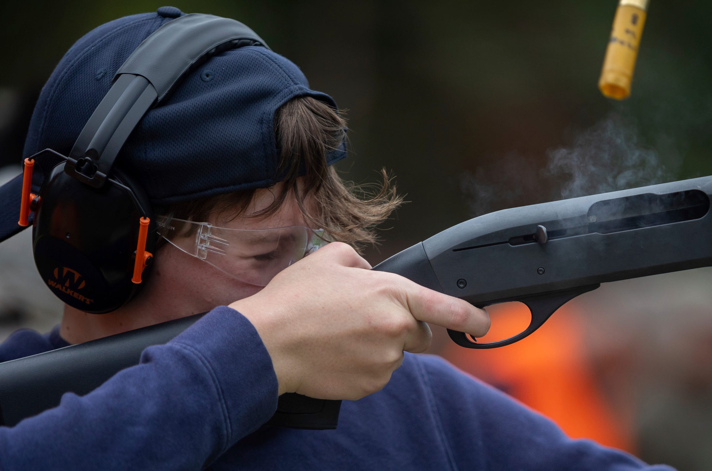 Richard Cooper, 12, closes his eyes as he shoots a clay target during a Hunter Safety Field Day at the Washtenaw Sportsman