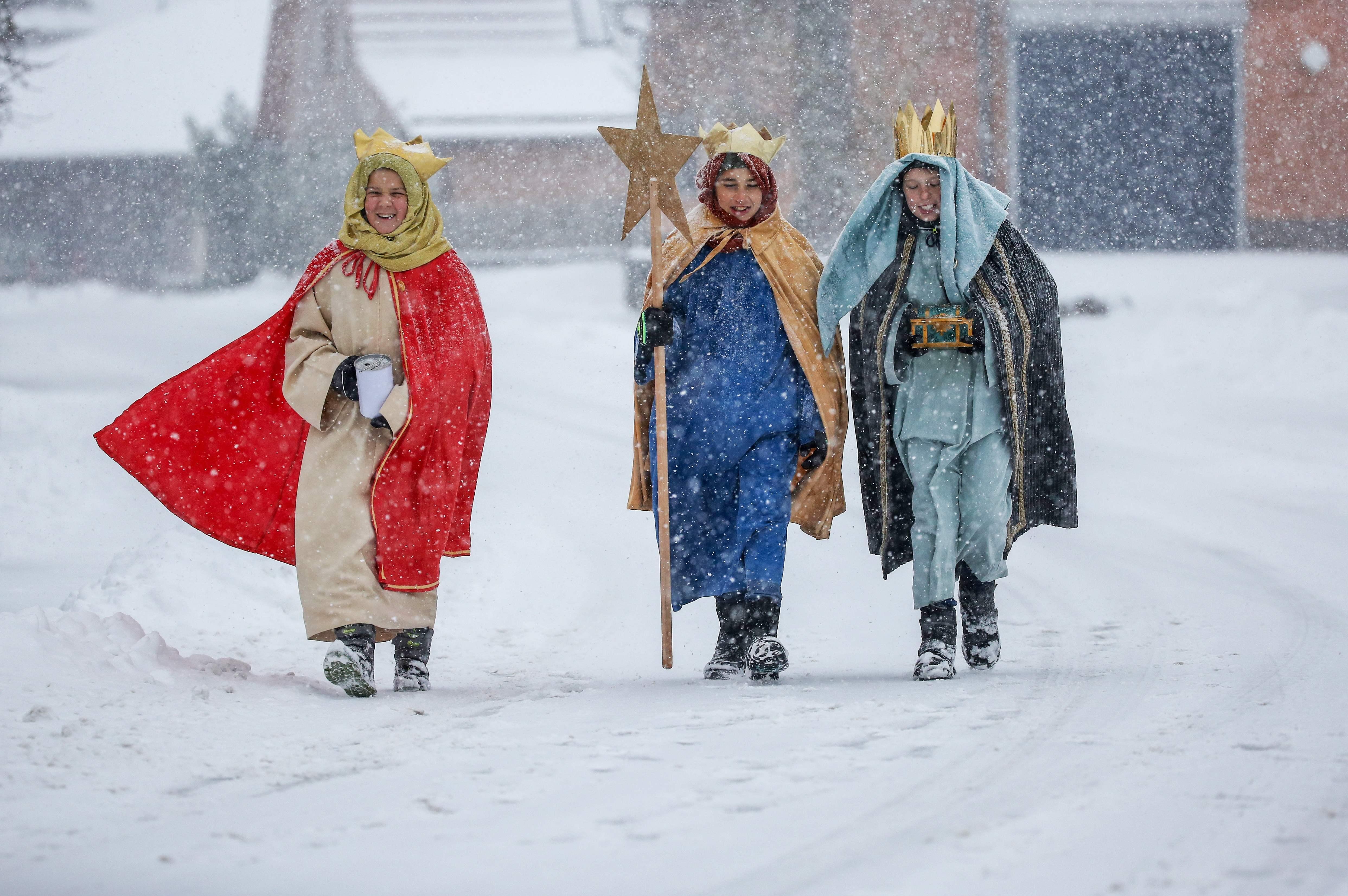 Carol singers dressed as the three Kings walk on the snow-covered path on the eve of the Epiphany celebrations on Jan. 5, 2019 in Lengenwang, Germany.