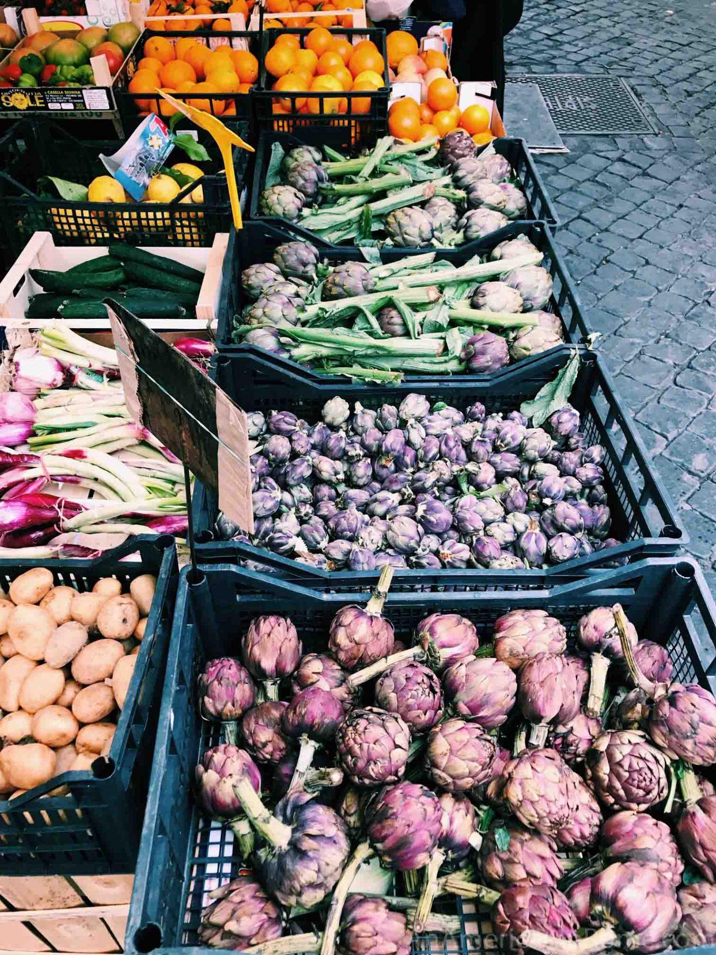three different kinds of artichokes at a market stalls in Rome