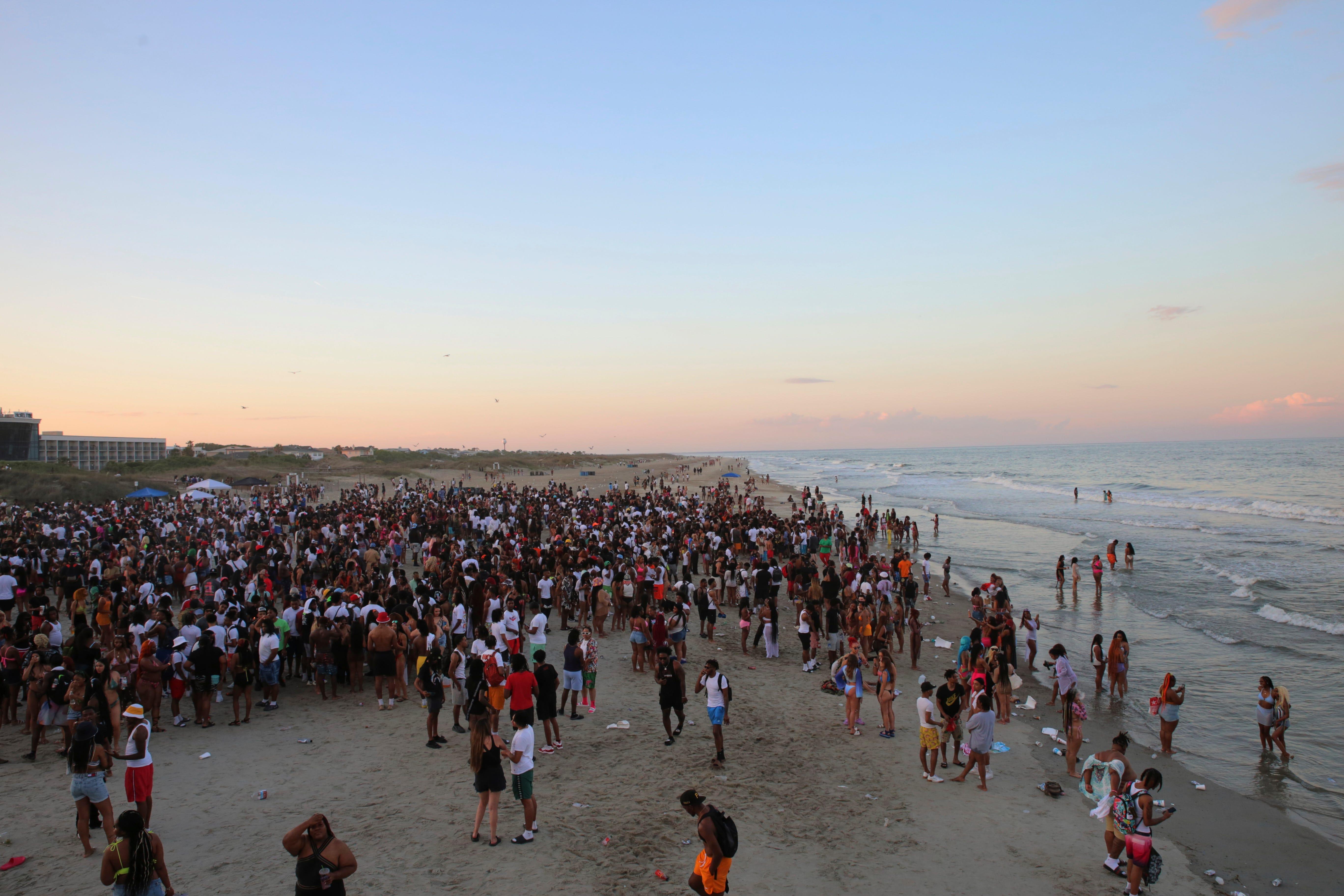 A large crowd of people enjoy the Tybee beach at sunset during Orange Crush on April 24.