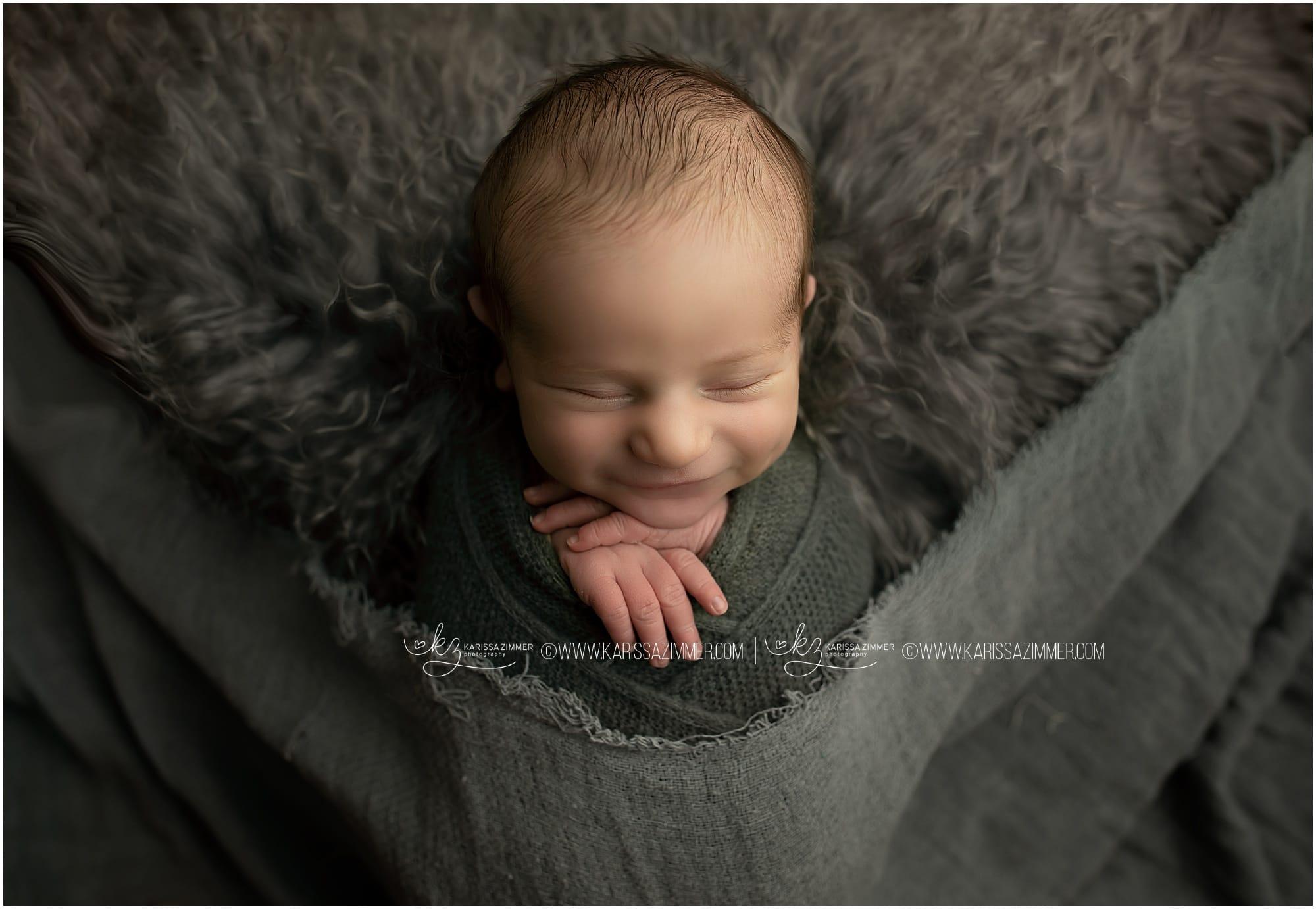 Newborn baby smiles at his Camp Hill photoshoot