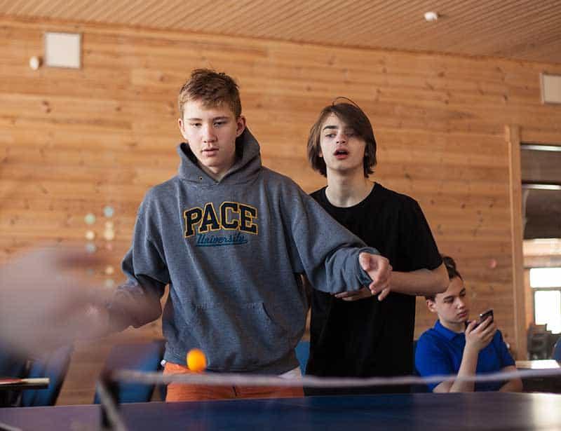 Young men at a youth club playing tabletennis