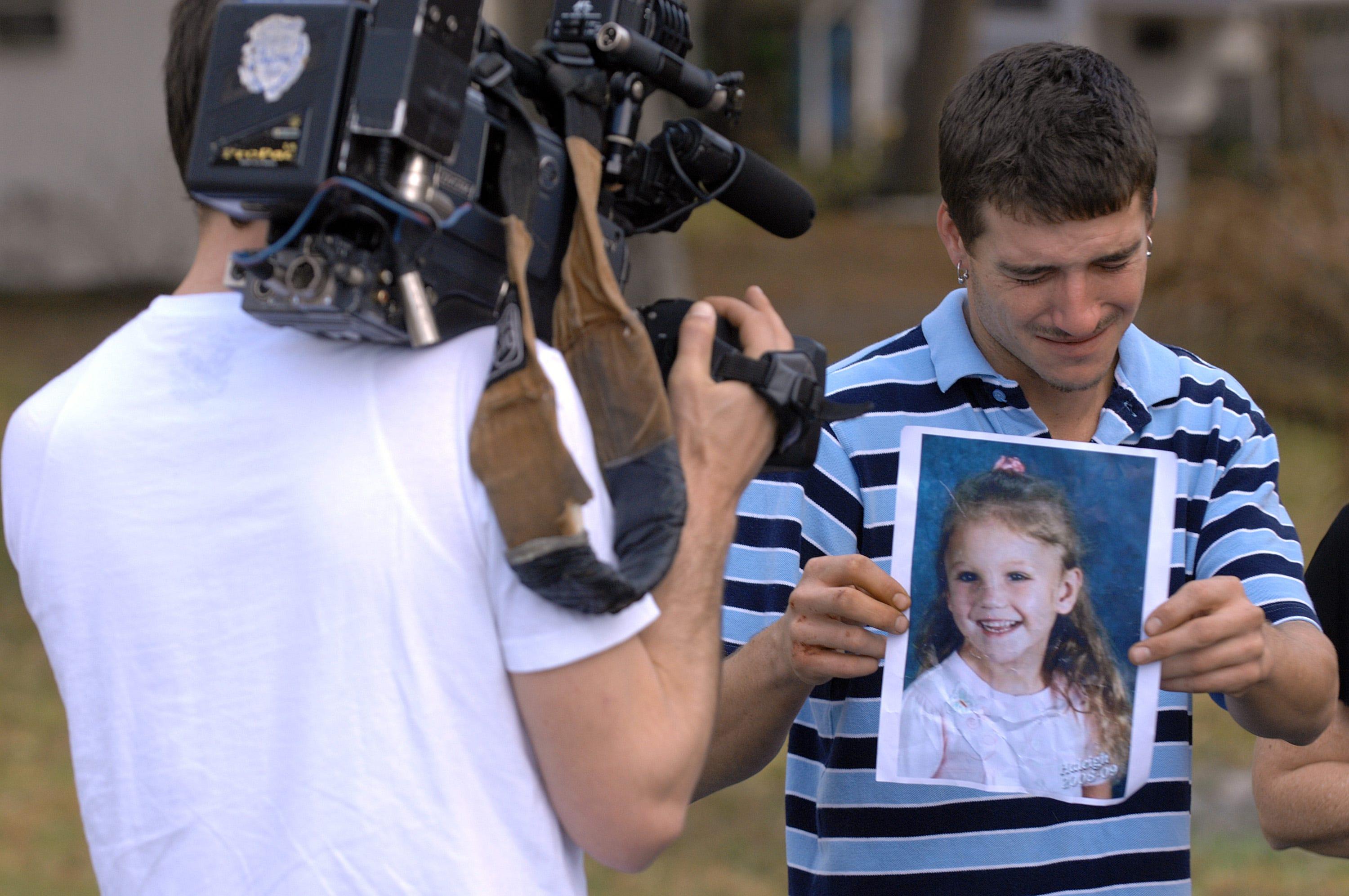 Ronald Cummings, the father of missing Haleigh Cummings, breaks down as he shows a photo of the 5-year-old for a TV videographer on Feb. 10, 2009. After serving 12 years on unrelated drug charges, Cummings was arrested again on Christmas Day.