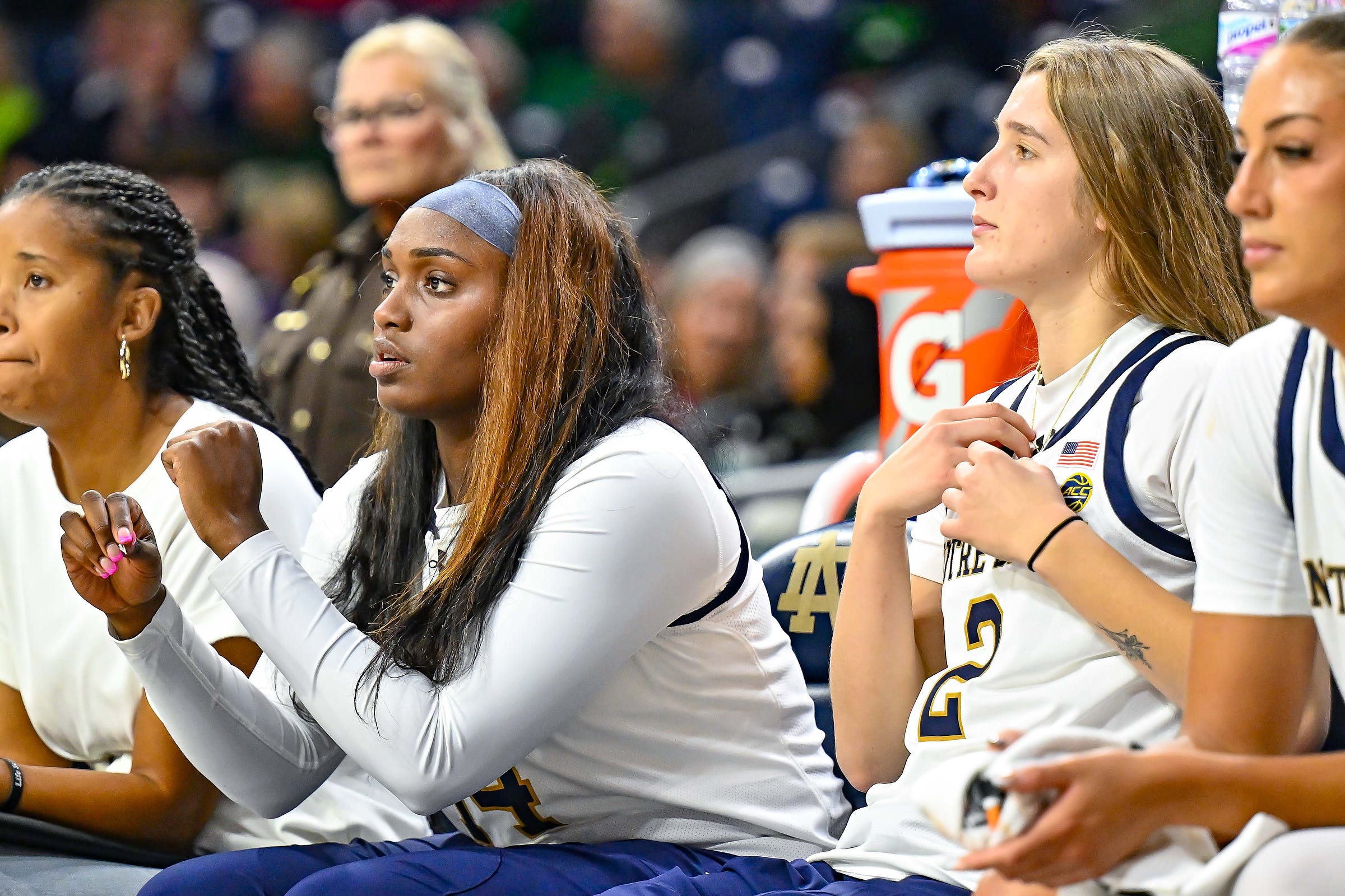 Notre Dame Fighting Irish guard KK Bransford (14) and guard Emma Risch (2) watch from the bench in the second half against Purdue Northwest Monday, Oct. 30, 2023, at the Purcell Pavilion.