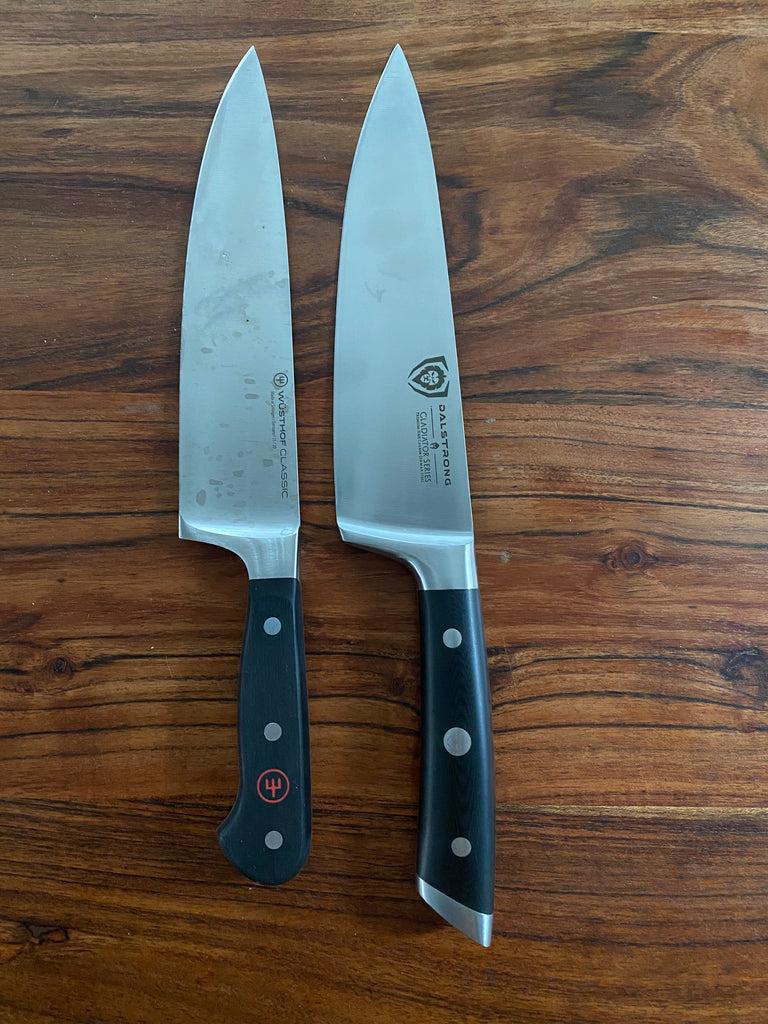 Wusthof knife next to a Dalstrong knife on a wooden surface