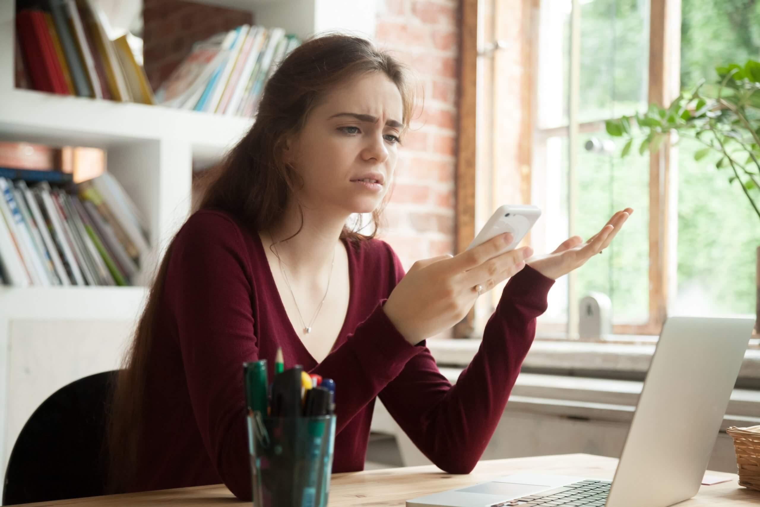 frustrated woman holding a phone